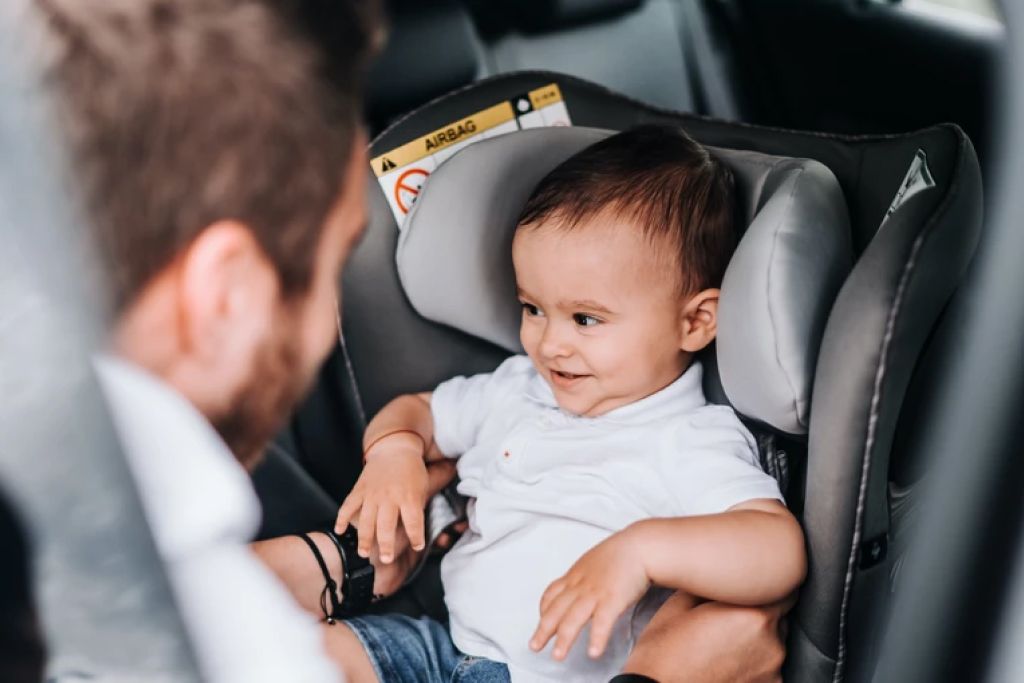 baby strapped in car seat