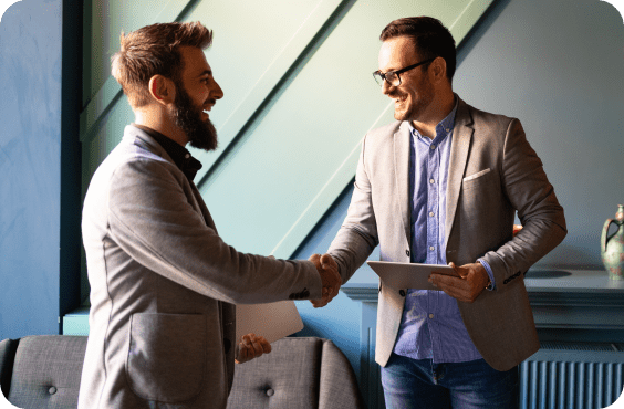 two men shaking hands in an office setting