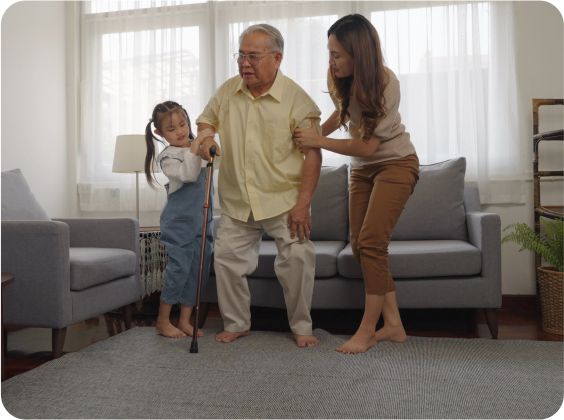 senior man helped by woman and child